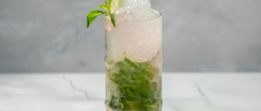 Verre de mojito litchi & lime fait avec du gin fruité sobr sans alcool